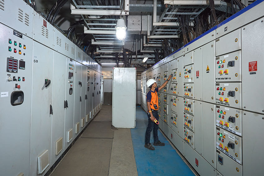 Worker checking machinery at balaji formalin production facility