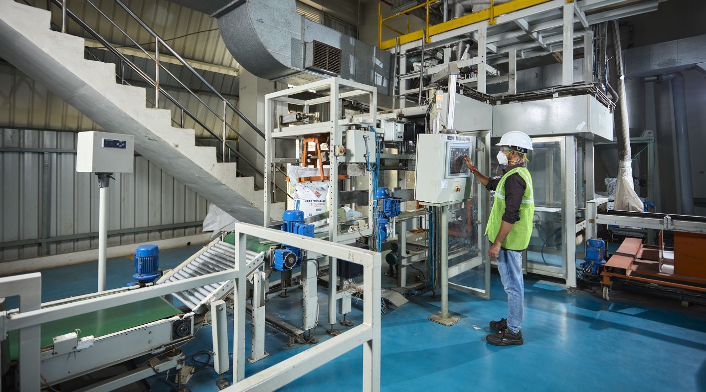 Worker checking machine screen in production house of balaji formalin