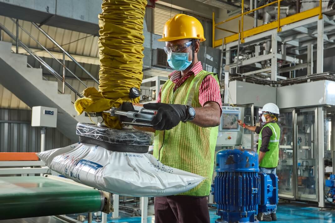 A worker is working on Paraformaldehyde packaing using an autometic carrying equipment